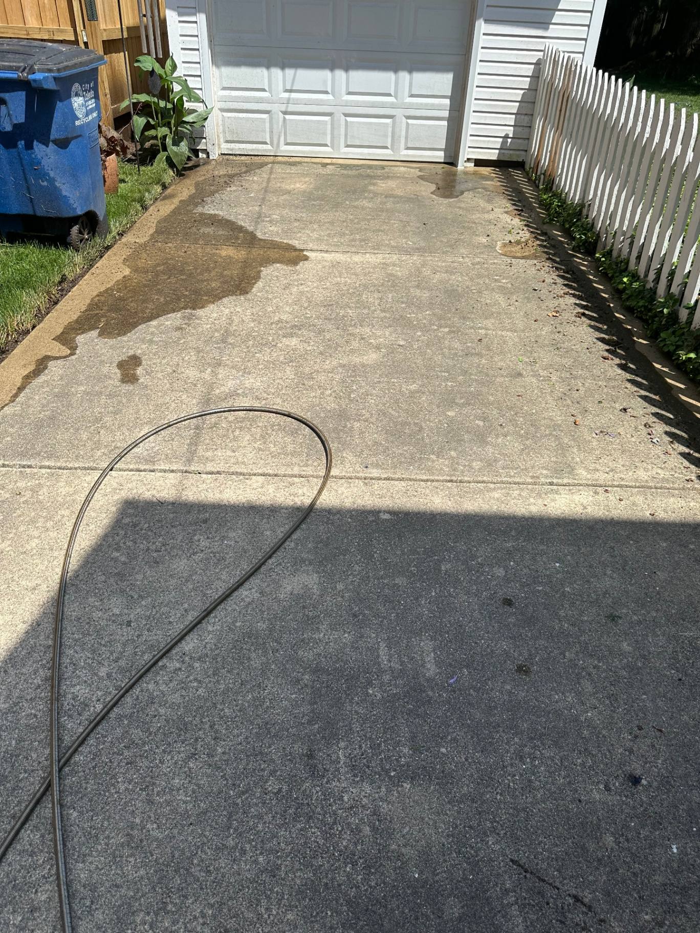Sylvania OH driveway before pressure washing with tire marks and oil stains