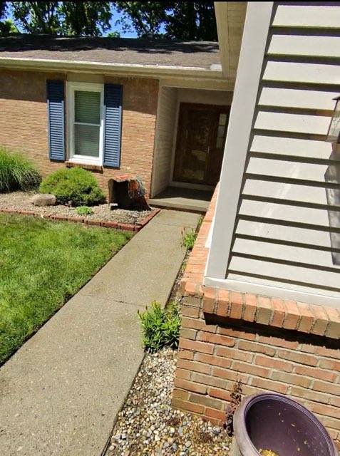Front walkway after pressure washing — clean concrete restored to its original light gray color